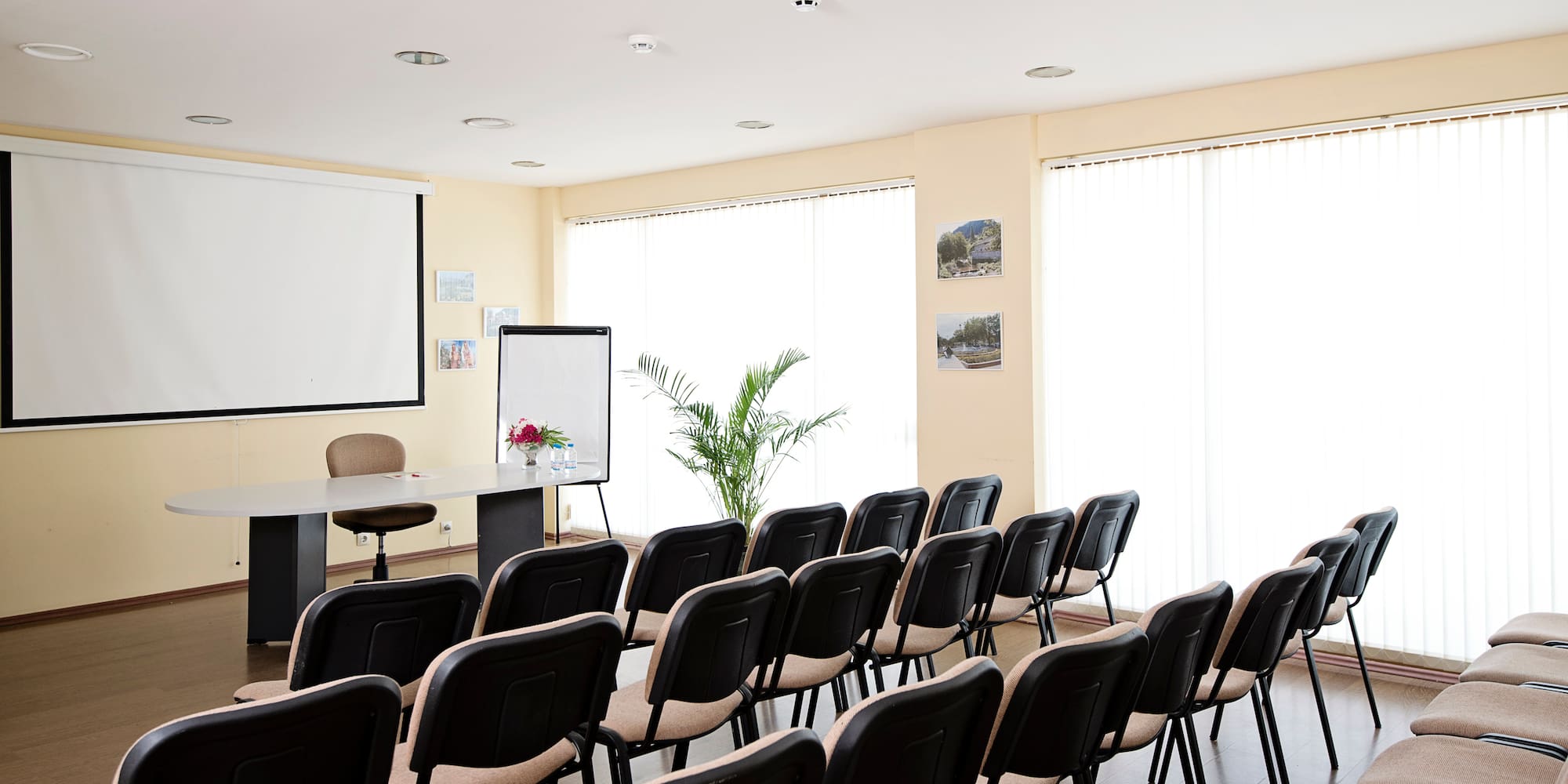 a room with chairs and a projector screen
