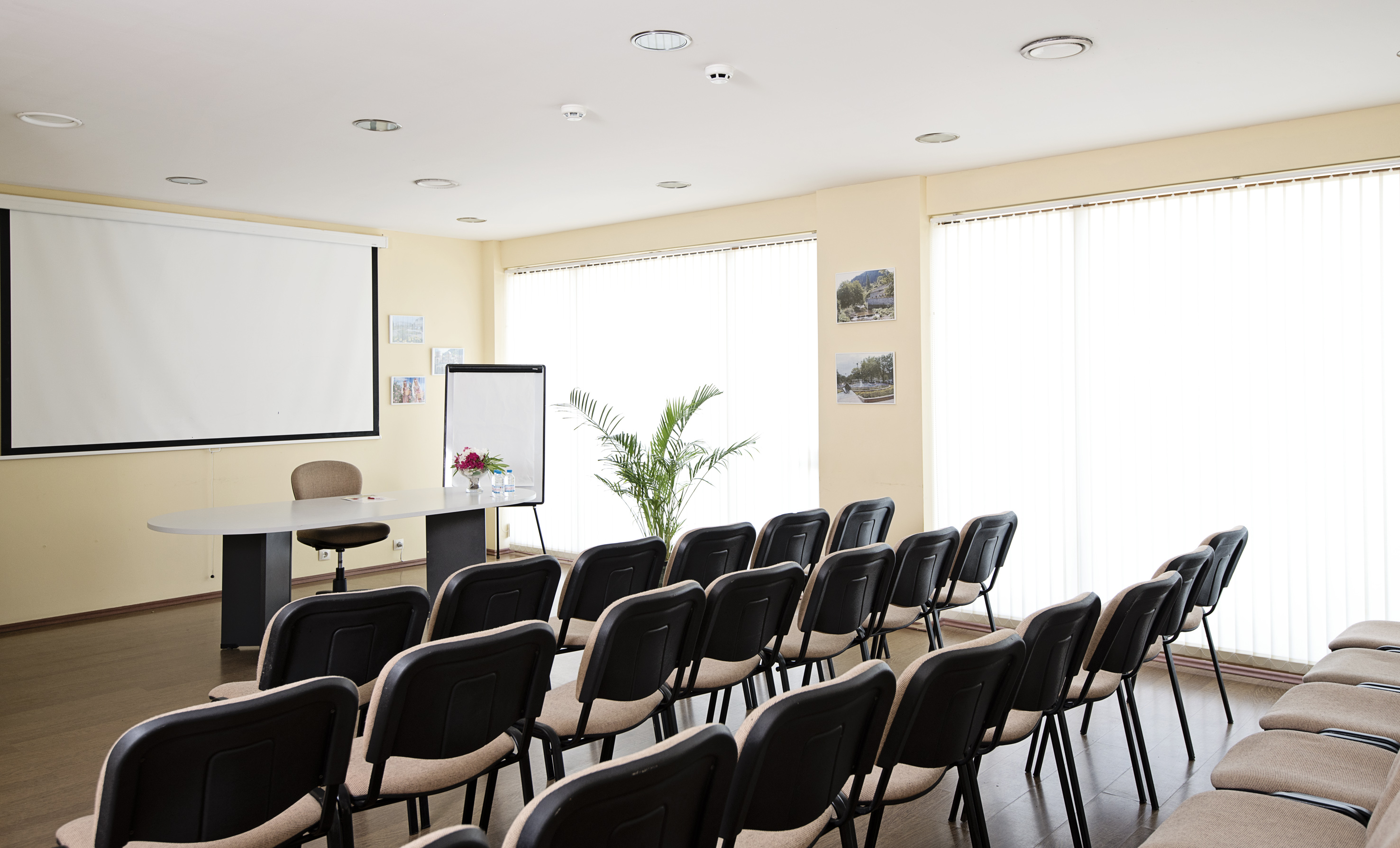a room with chairs and a projector screen