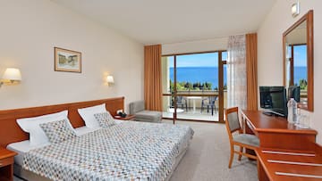 a bedroom with a bed and a desk and chair