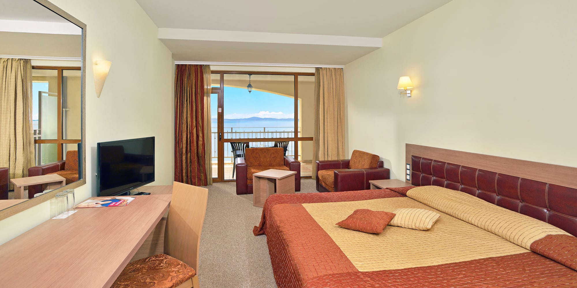 a room with a bed and a television