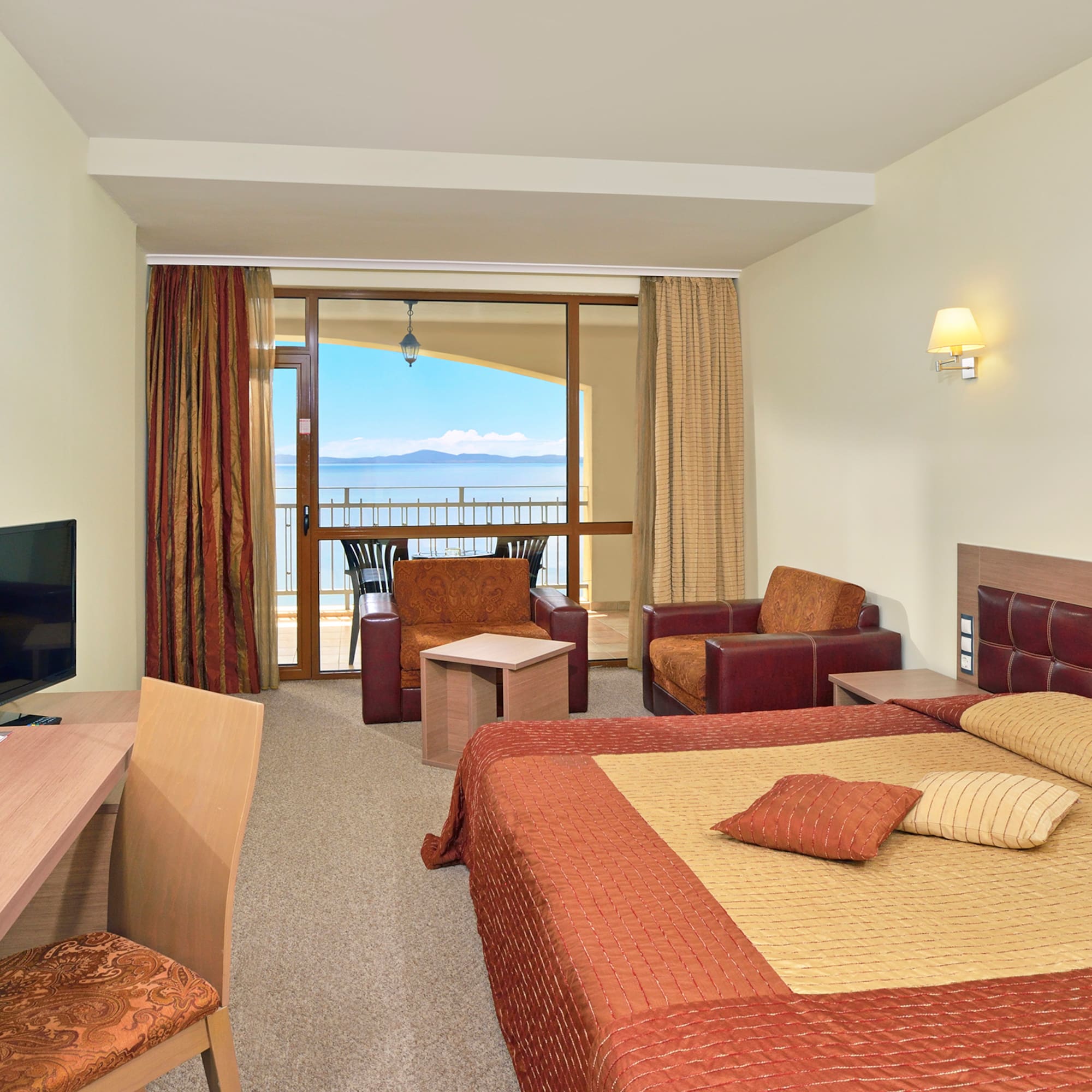 a room with a bed and a television