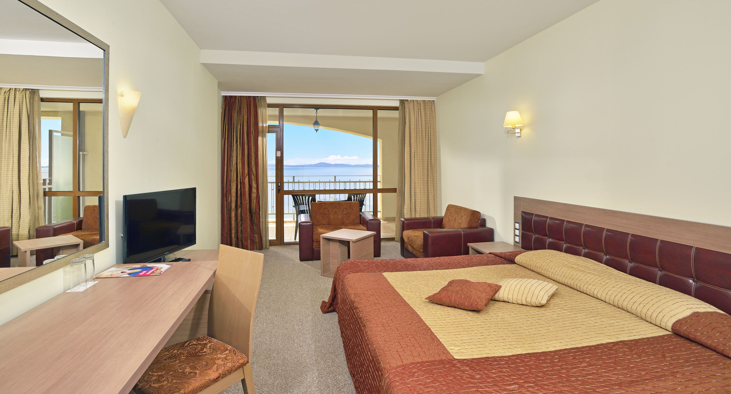 a room with a bed and a television