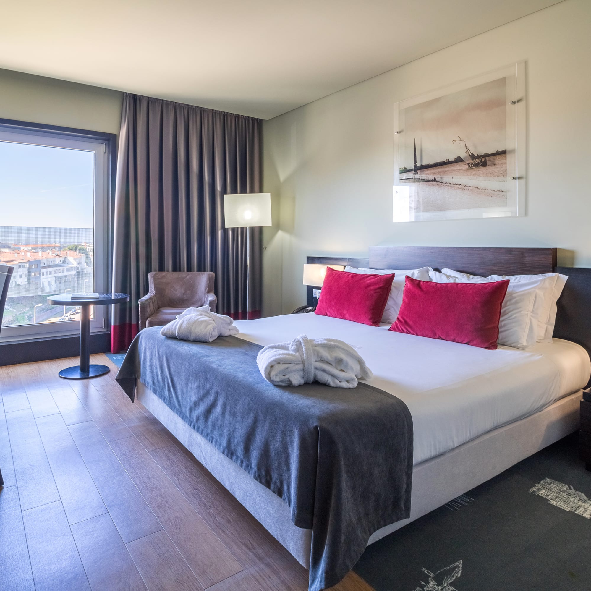 a hotel room with a bed and chairs