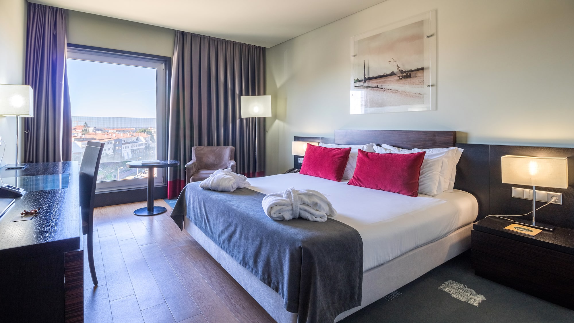 a hotel room with a bed and chairs