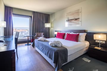 a hotel room with a bed and chairs