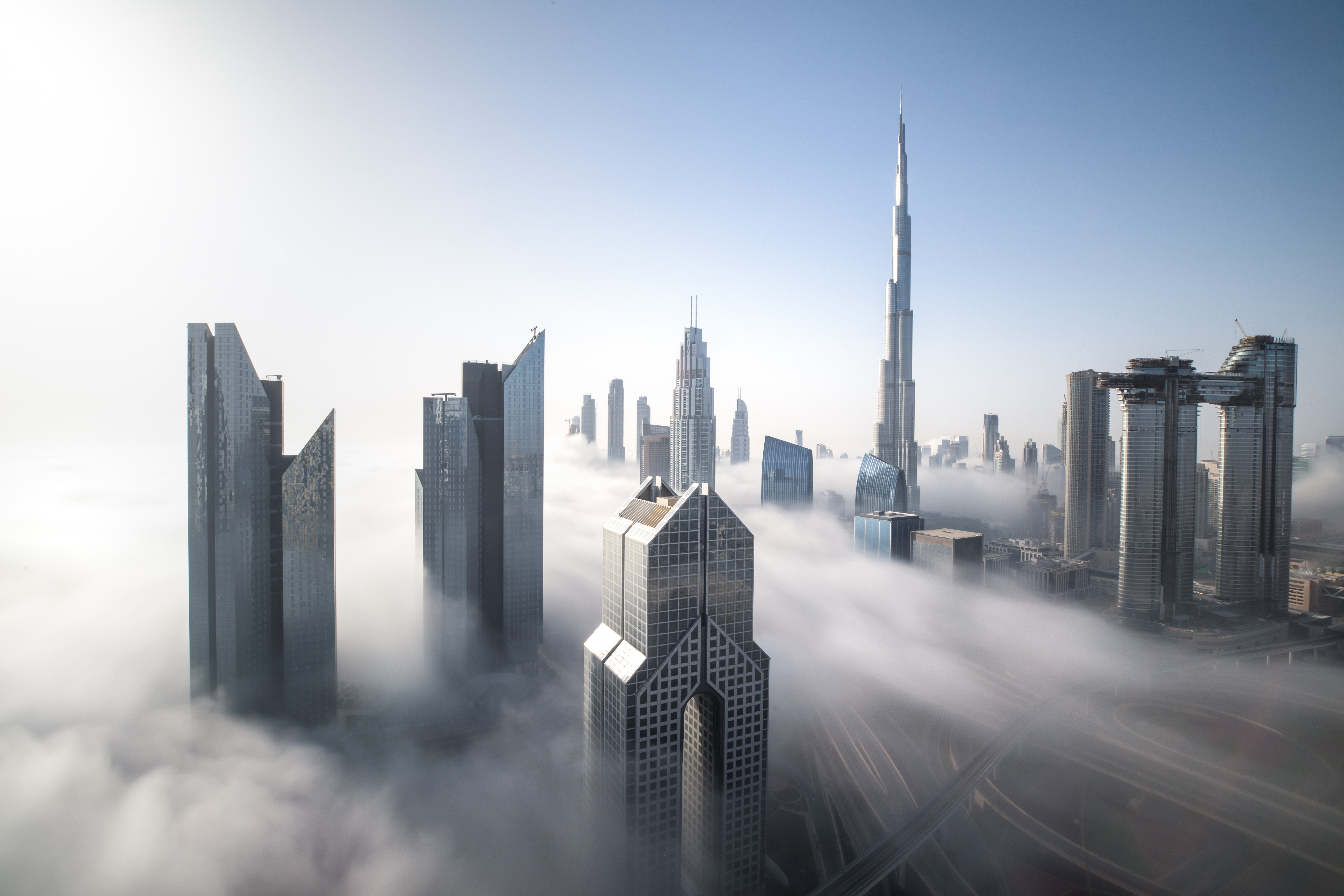 a city with many tall buildings and fog