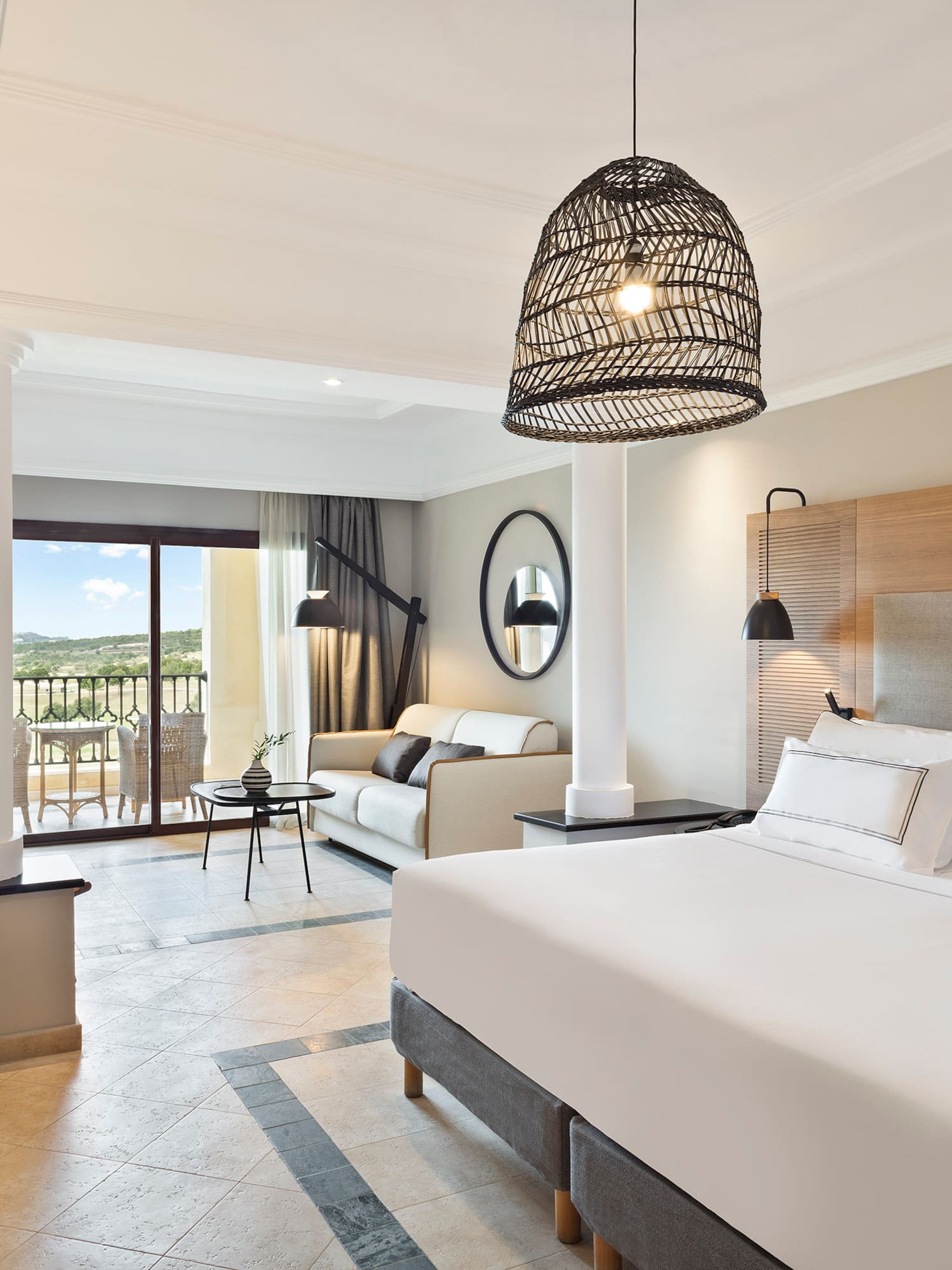 a bedroom with a large bed and a large sofa