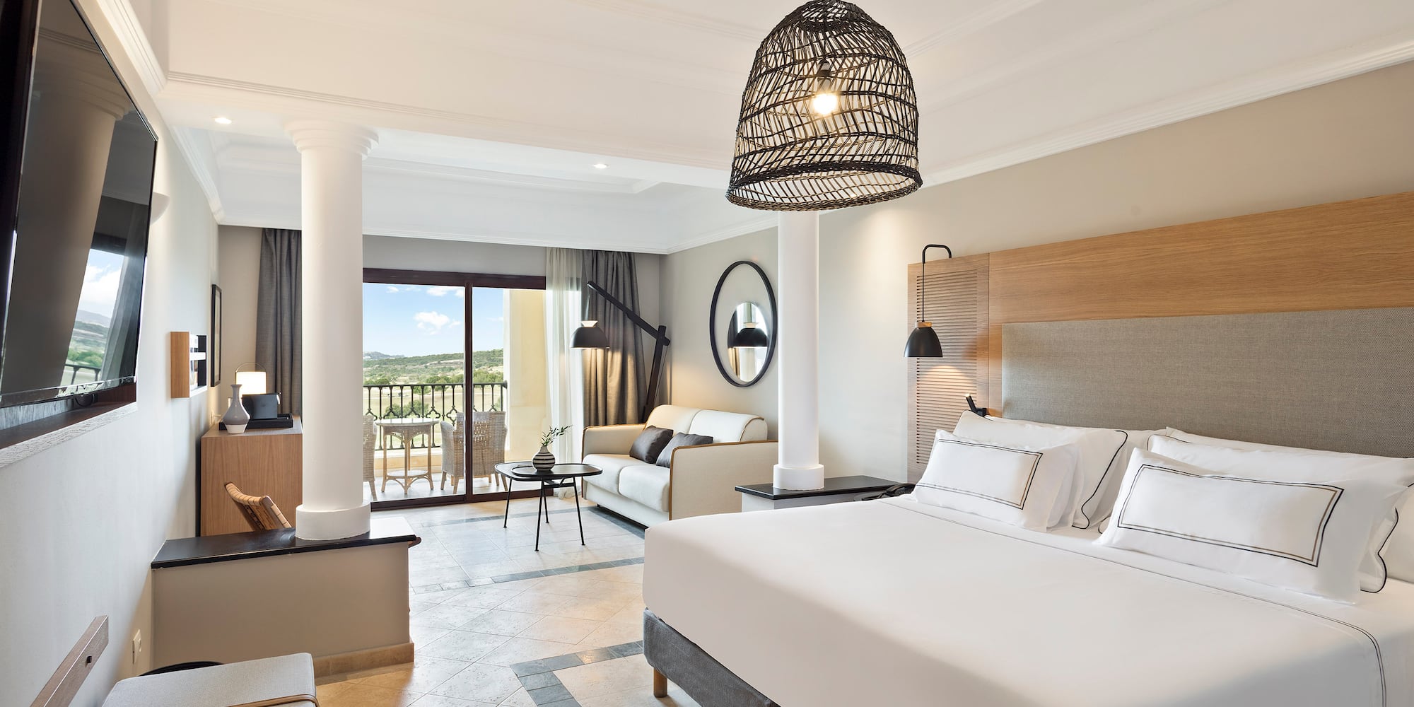 a bedroom with a large bed and a large sofa