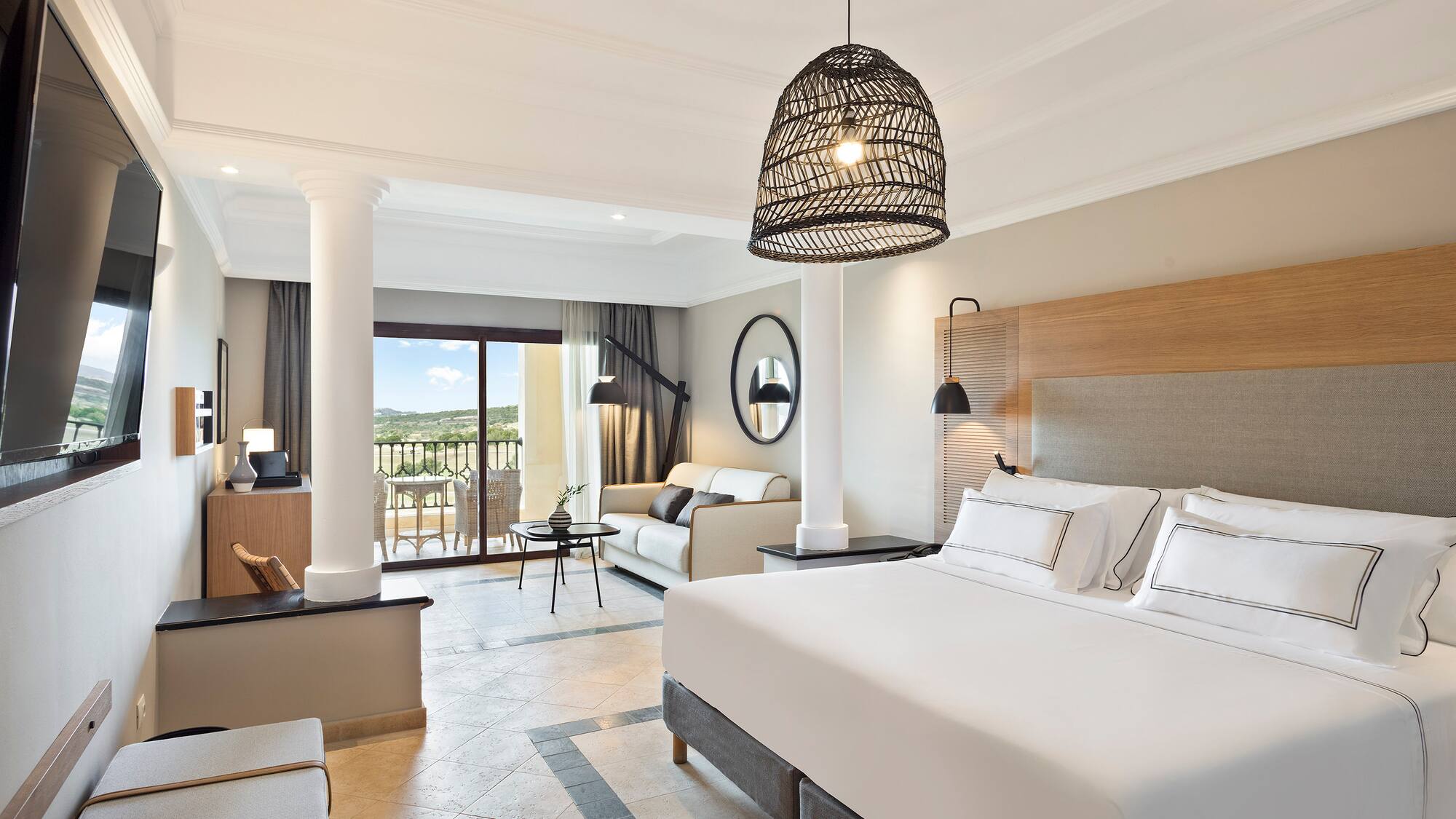 a bedroom with a large bed and a large sofa