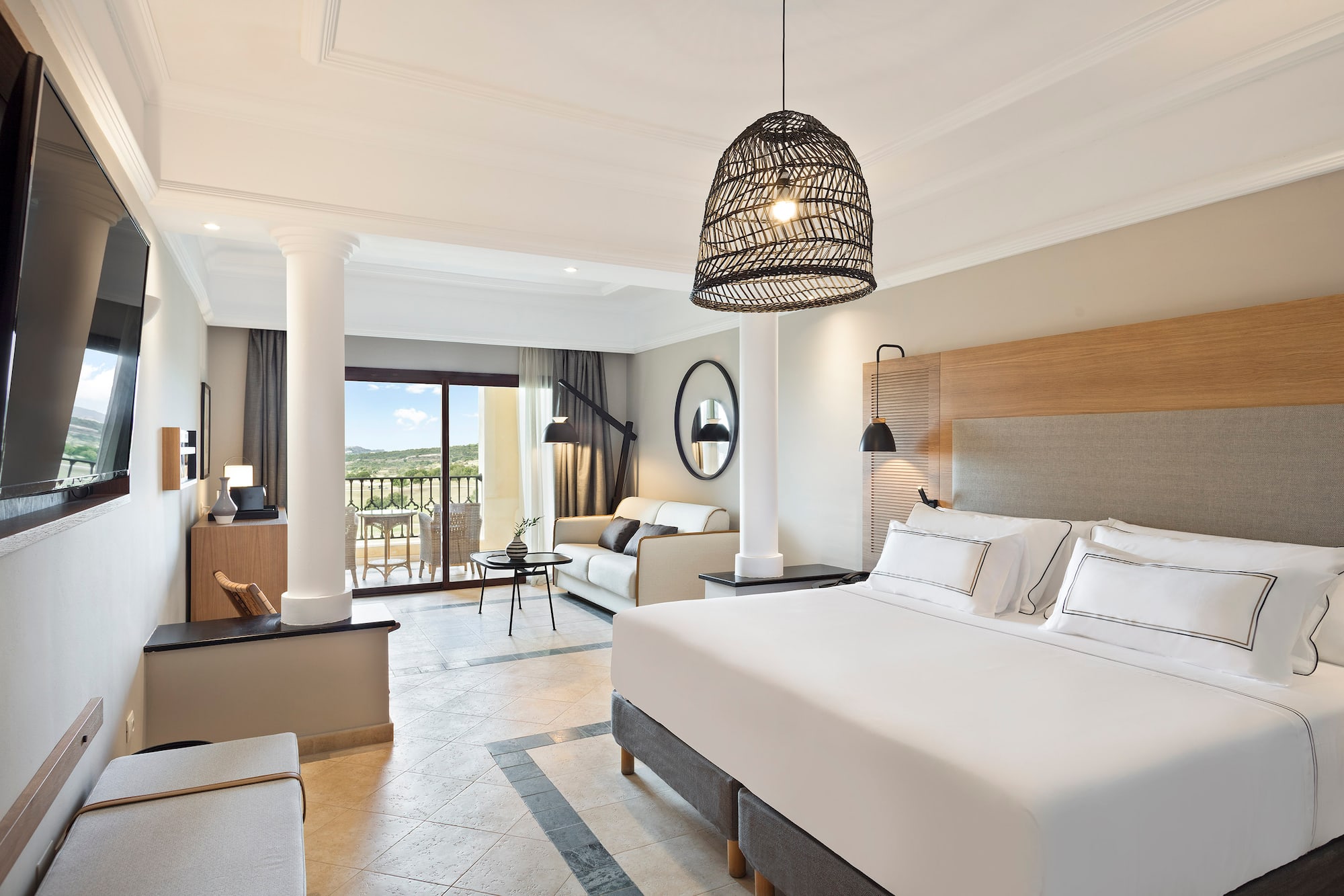 a bedroom with a large bed and a large sofa