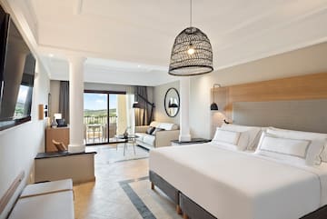 a bedroom with a large bed and a large sofa