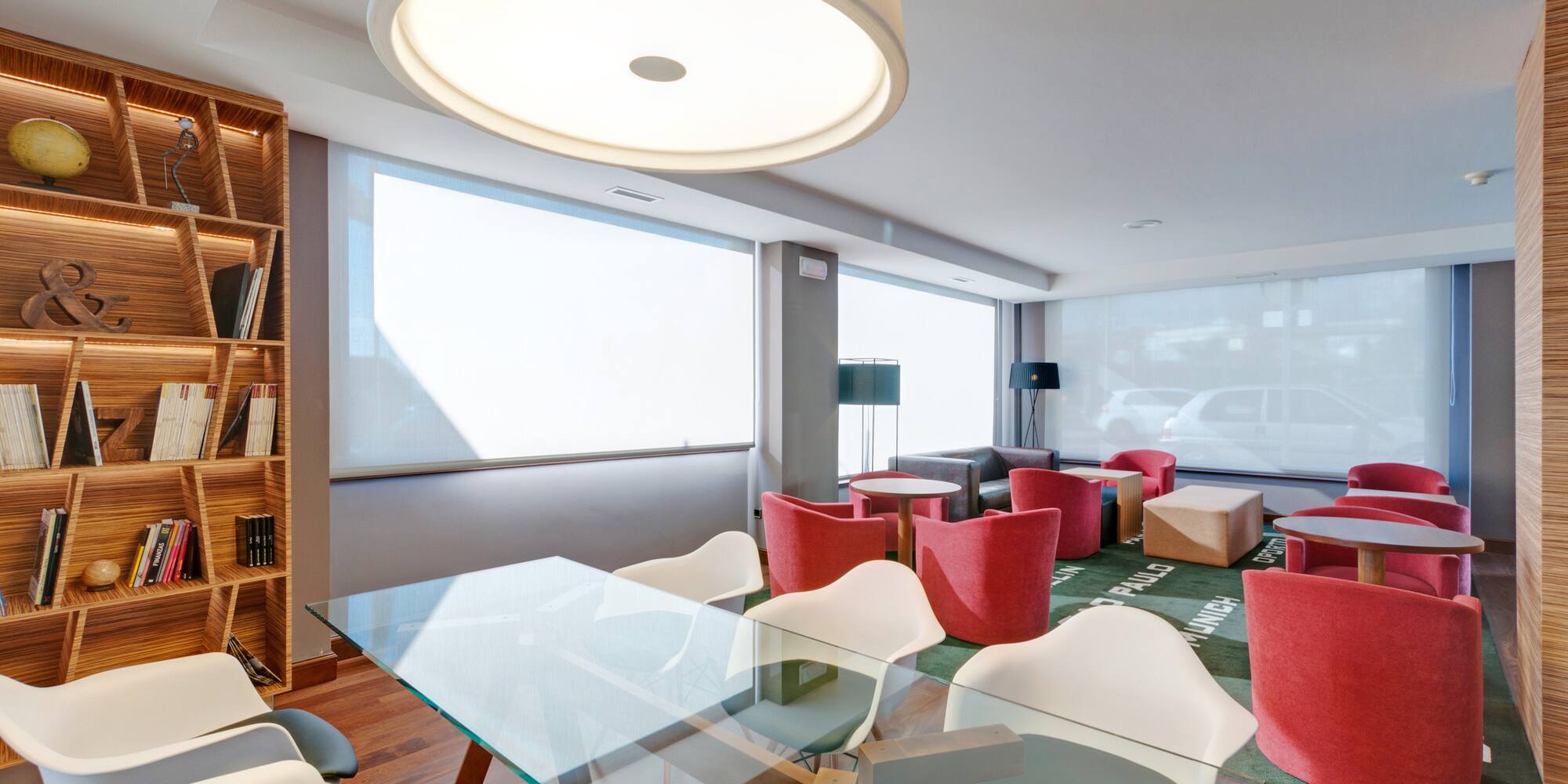 a room with a glass table and chairs