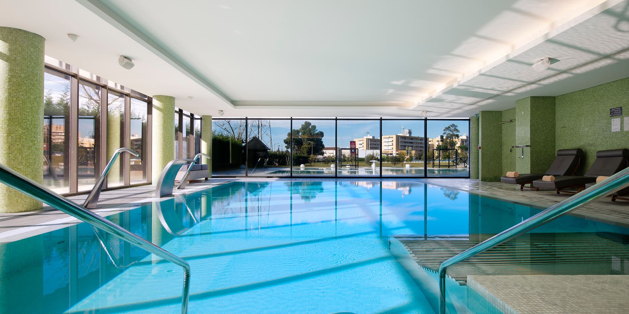 a swimming pool with stairs and stairs leading to a building