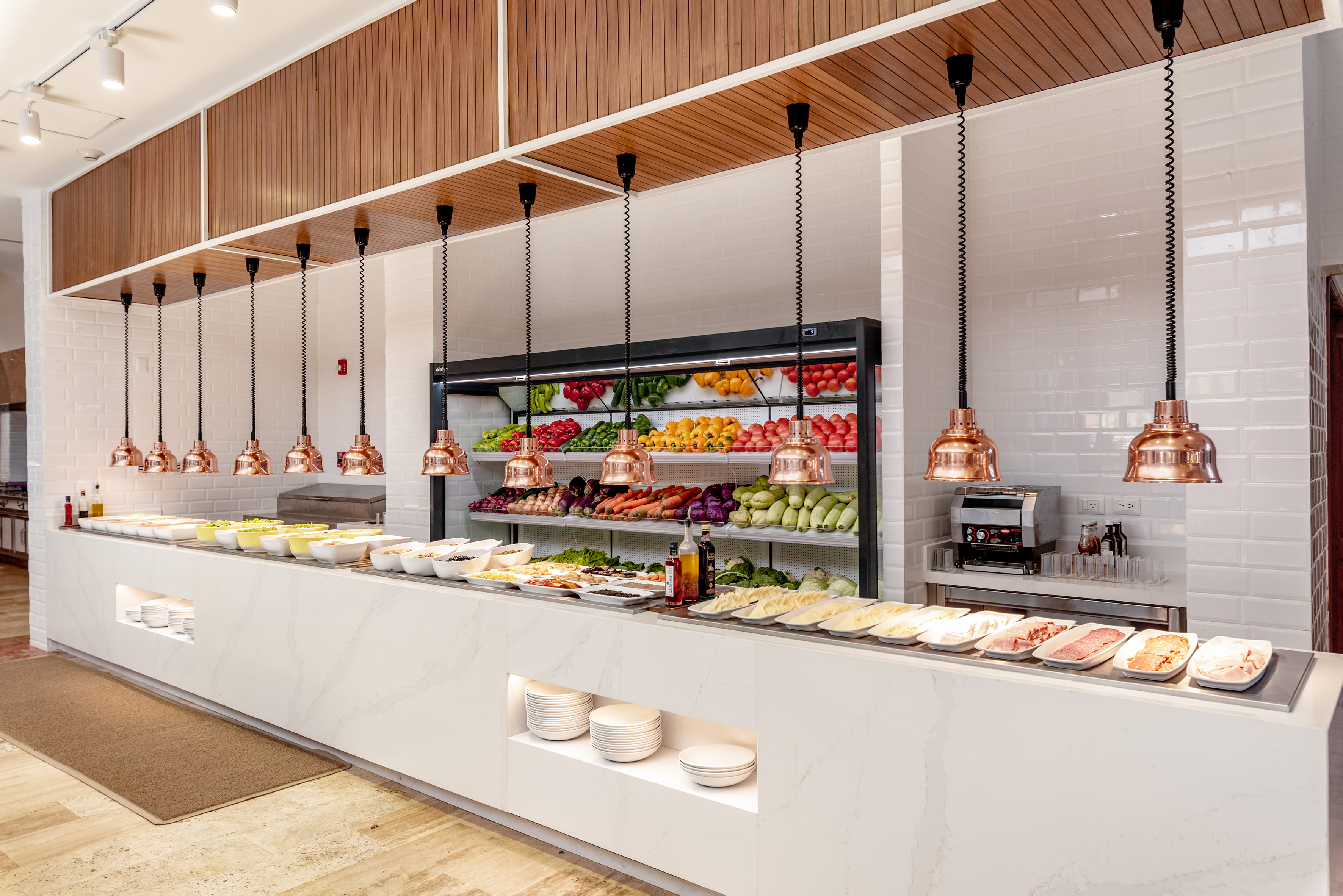 Hotel buffet with fresh produce, salads, and prepared food items.