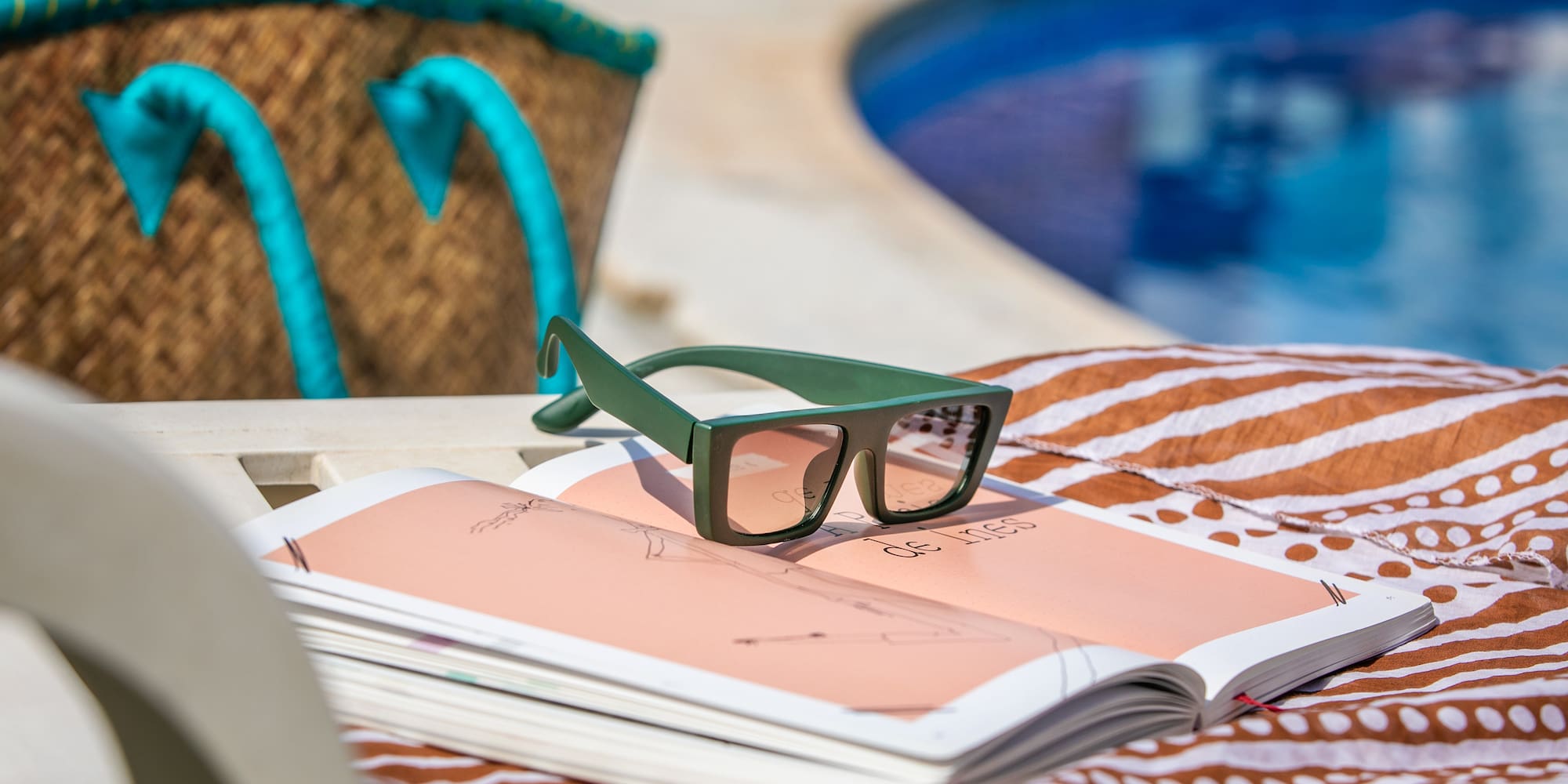 a book and sunglasses on a beach chair