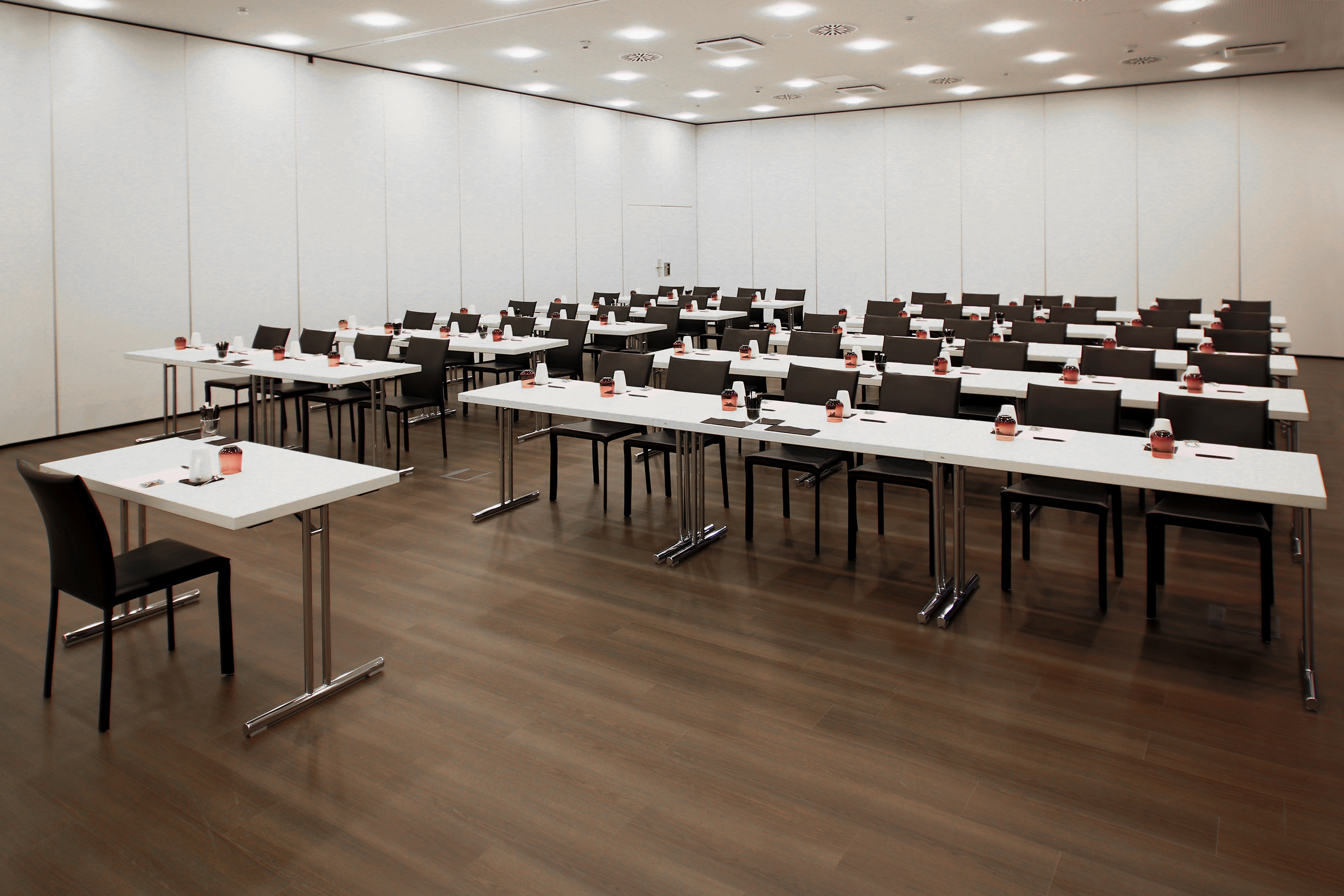 Modern conference room with white tables, dark chairs, set for meetings. - Bentley - INNSiDE Wolfsburg, Wolfsburg