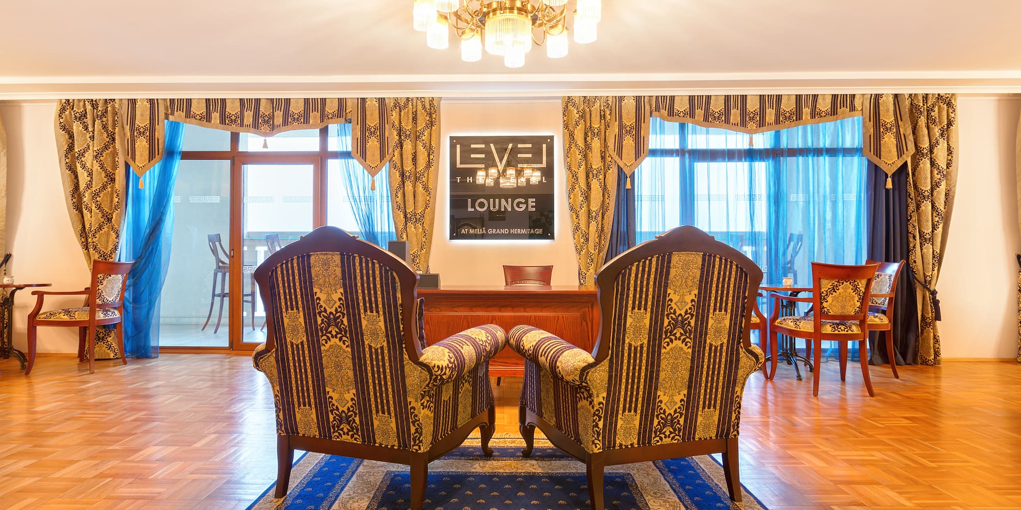 a room with chairs and a chandelier