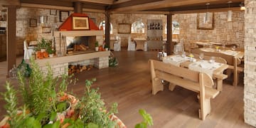 a room with a table and chairs and a fireplace