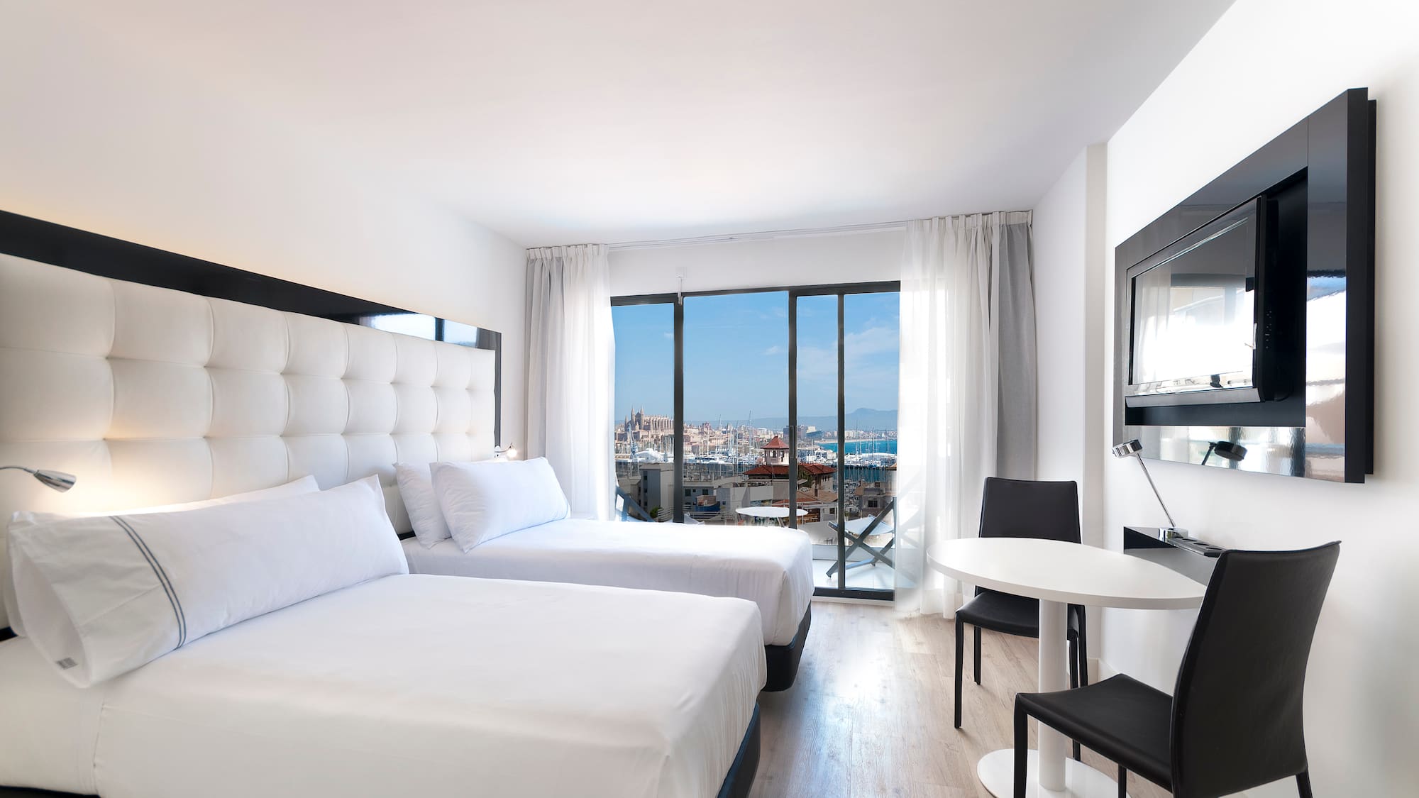 a room with two beds and a table