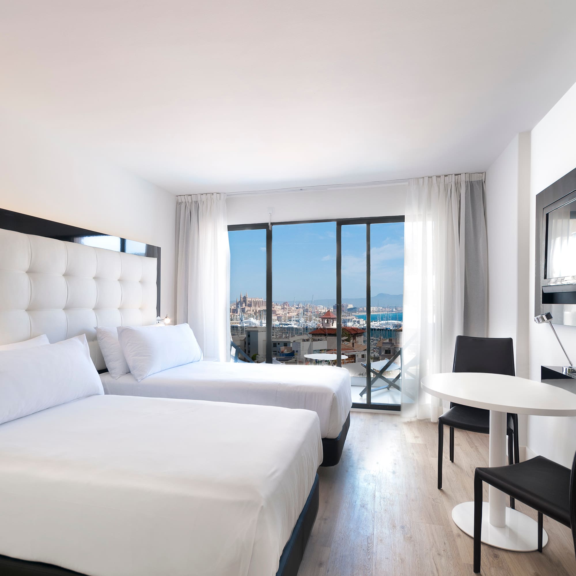 a room with two beds and a table