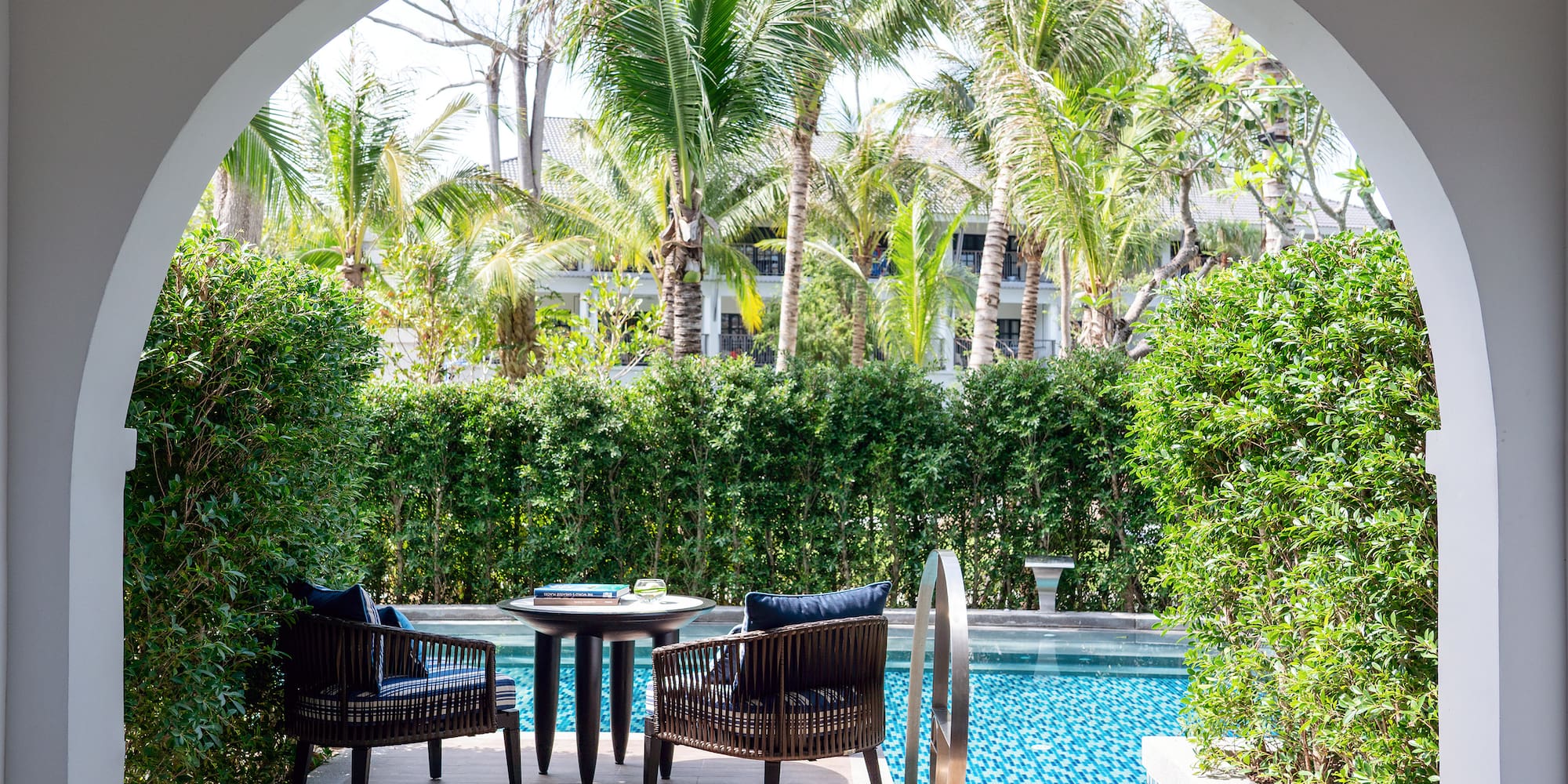 a pool with chairs and tables