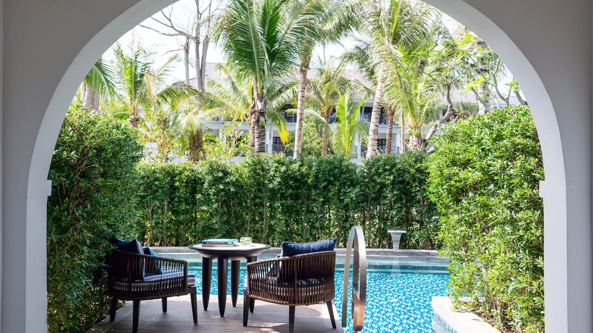 a pool with chairs and tables