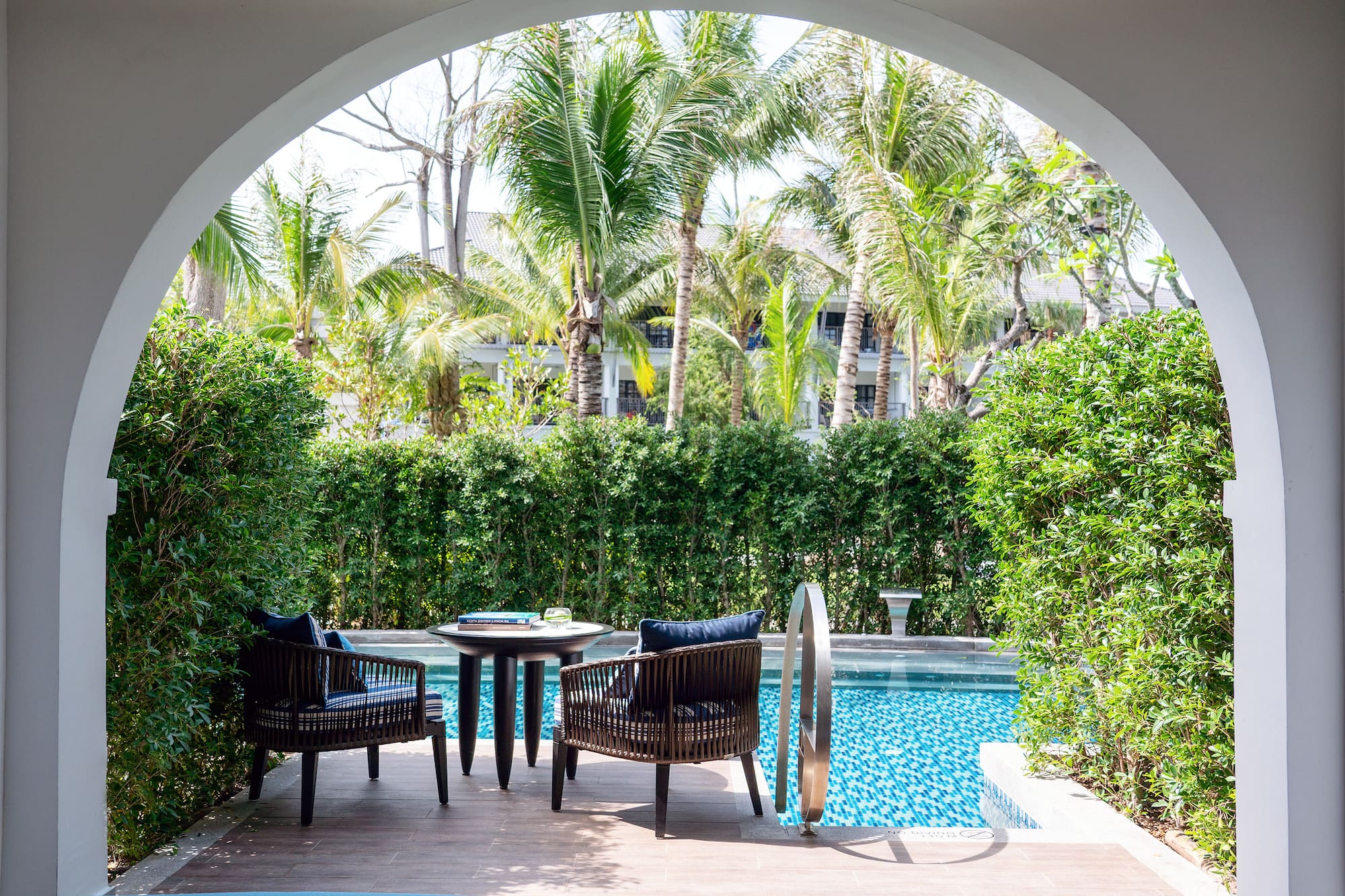 a pool with chairs and tables