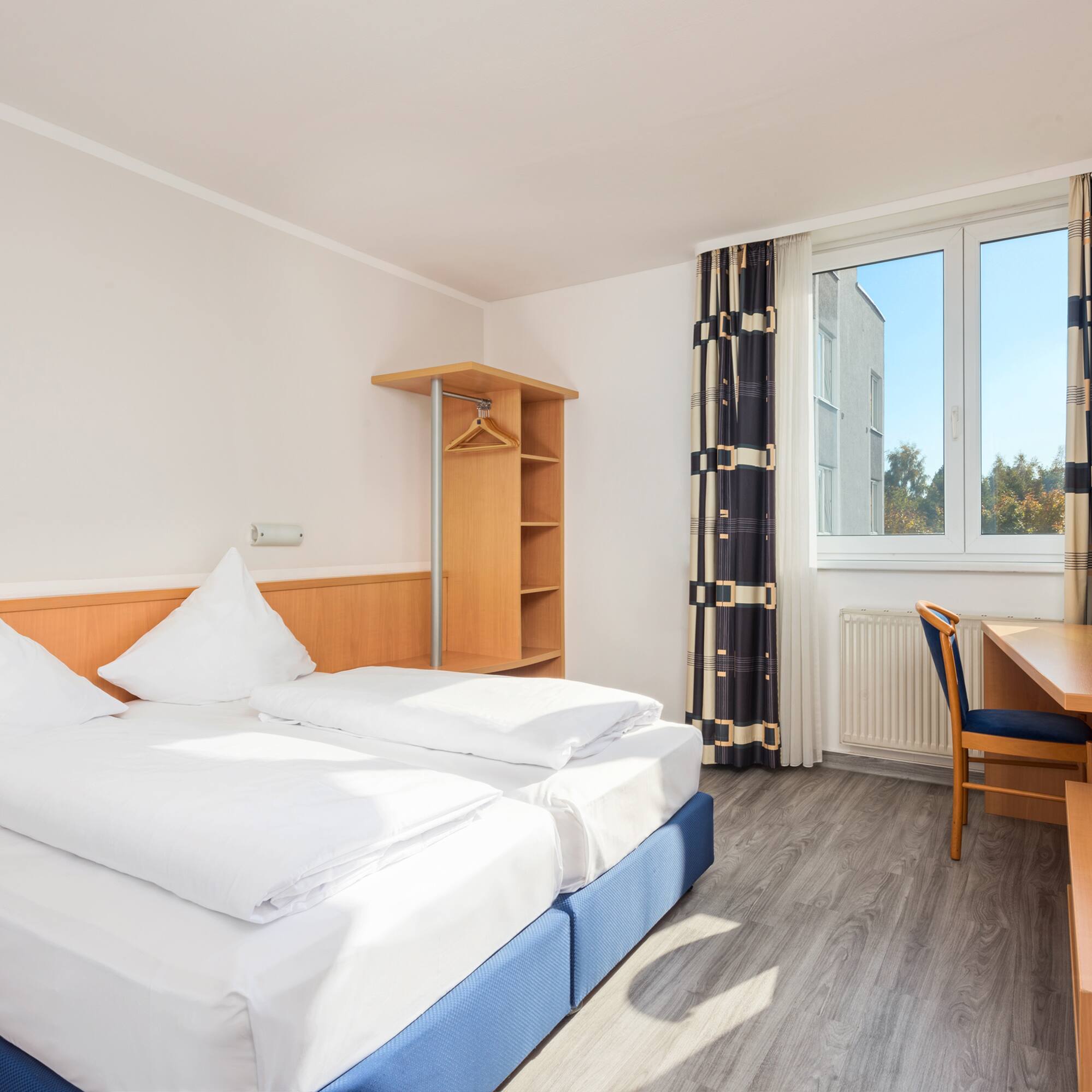 a room with a bed and desk