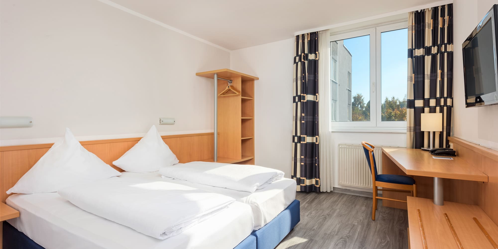 a room with a bed and desk