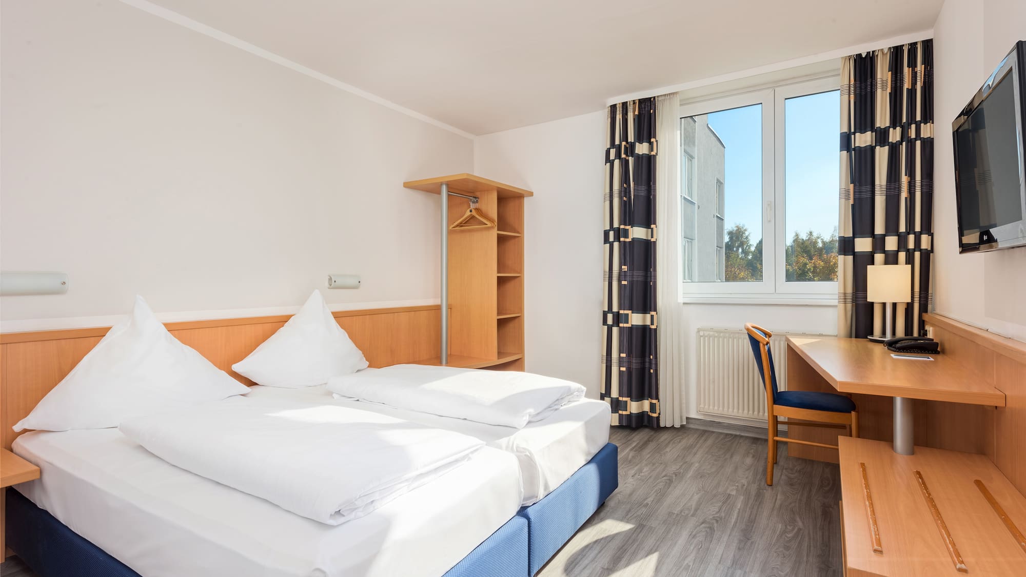 a room with a bed and desk