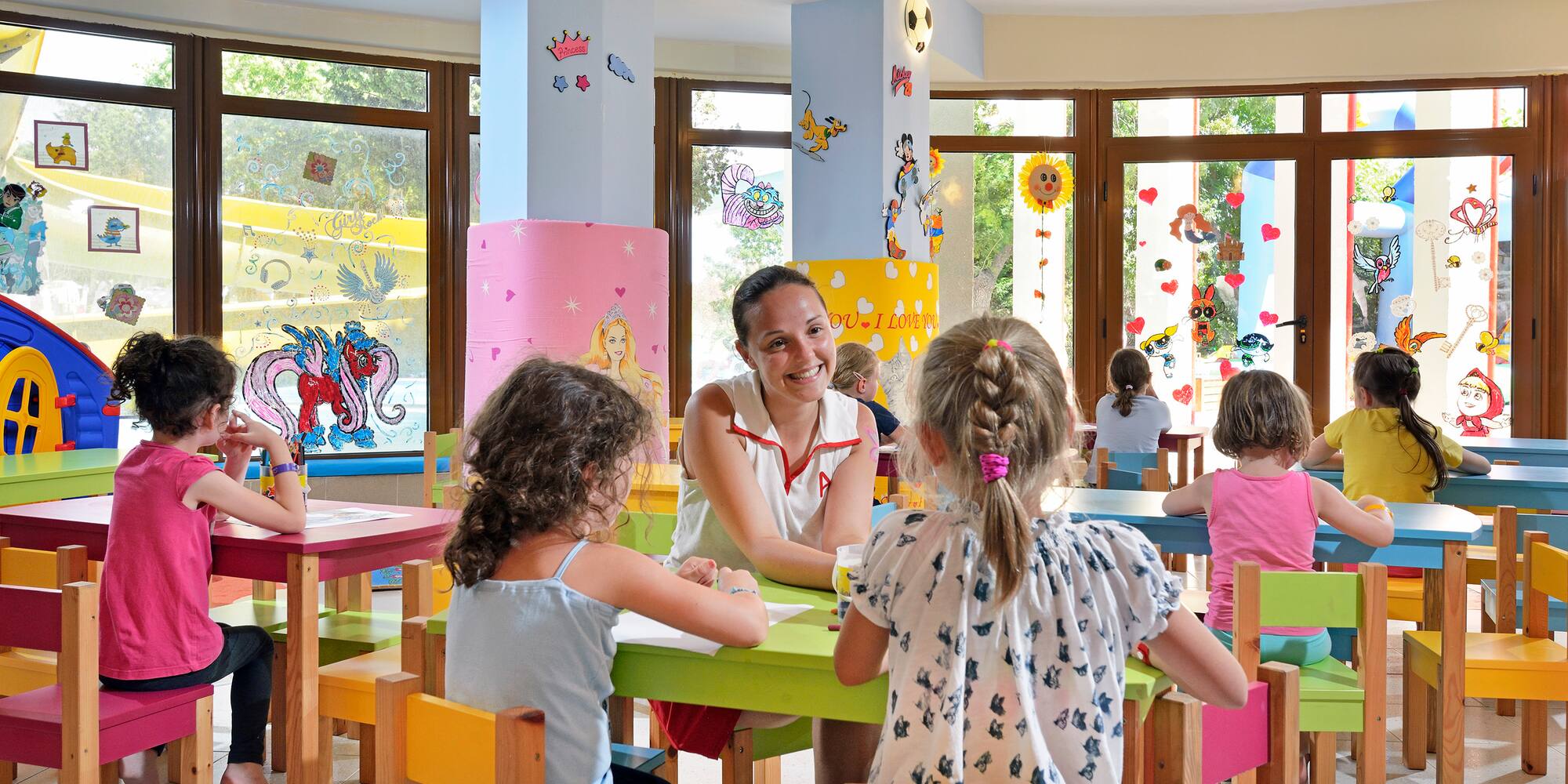 a woman sitting at a table with children