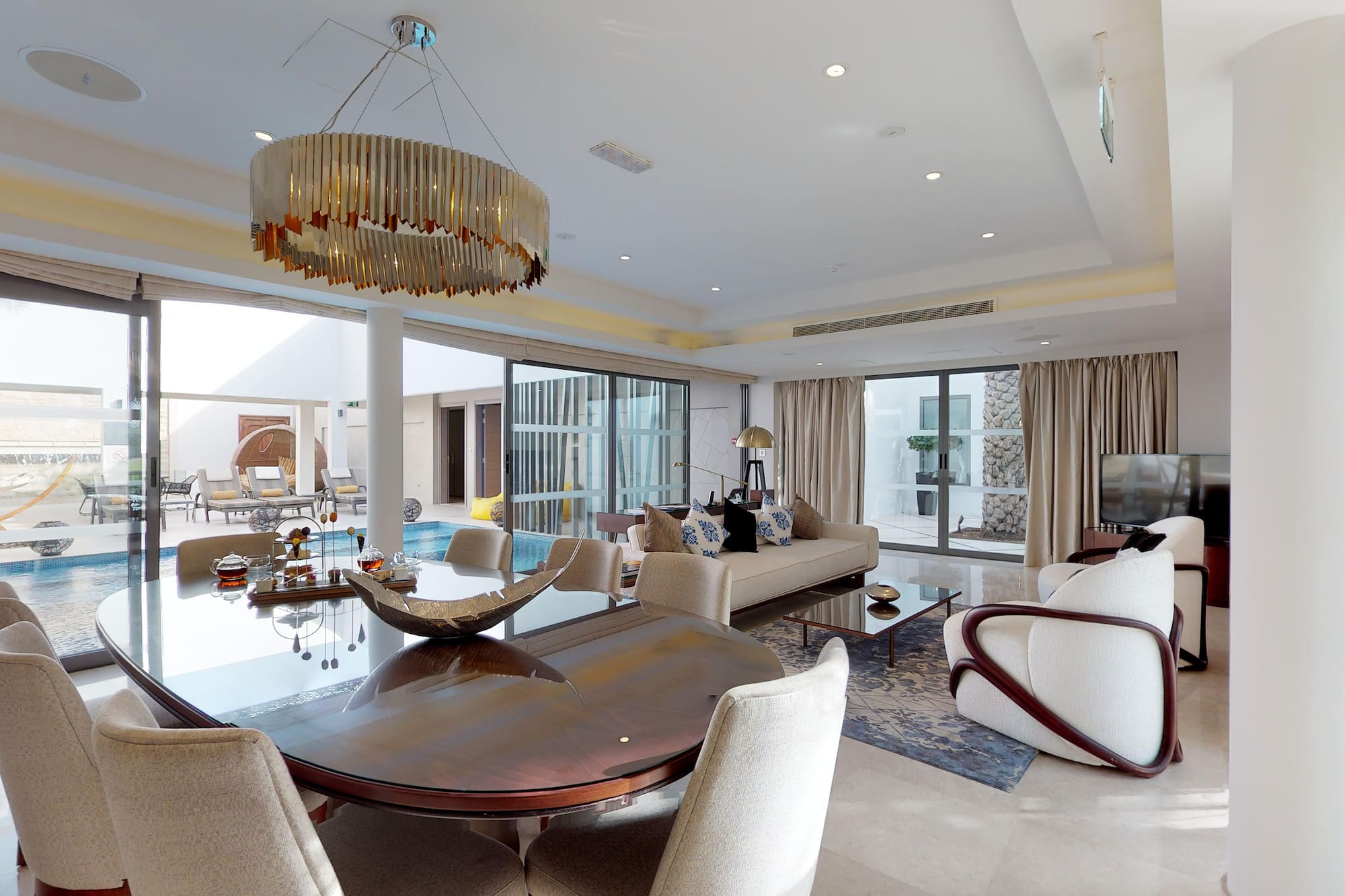 a living room with a large table and chairs