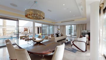 a living room with a large table and chairs