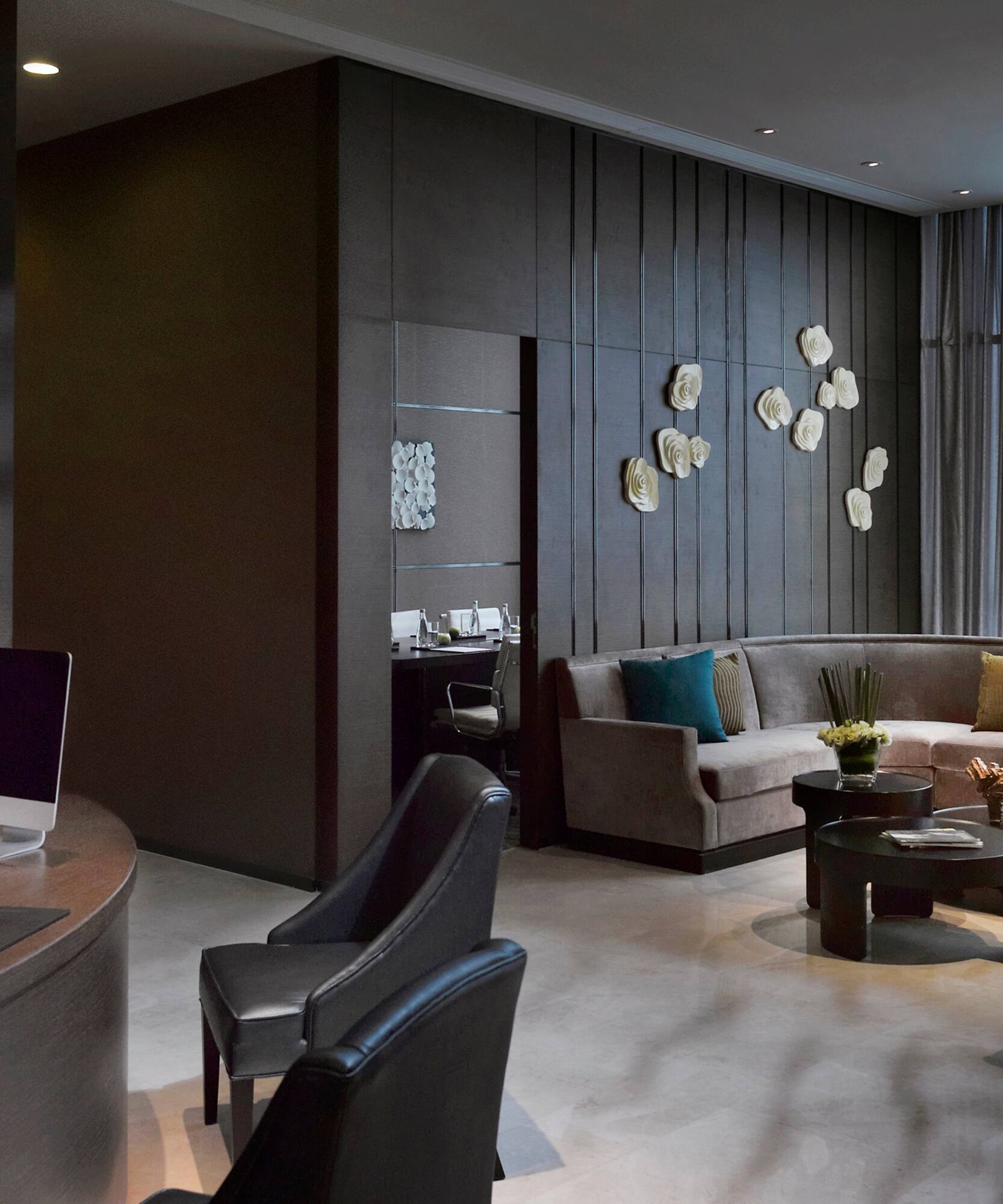 a room with a round table and couches