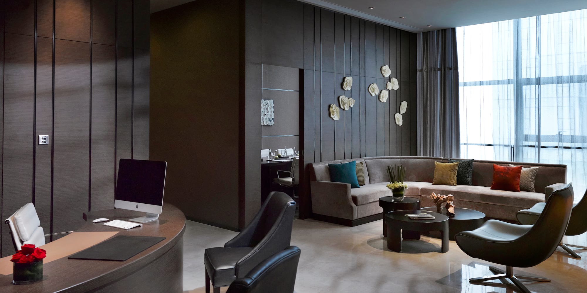 a room with a round table and couches