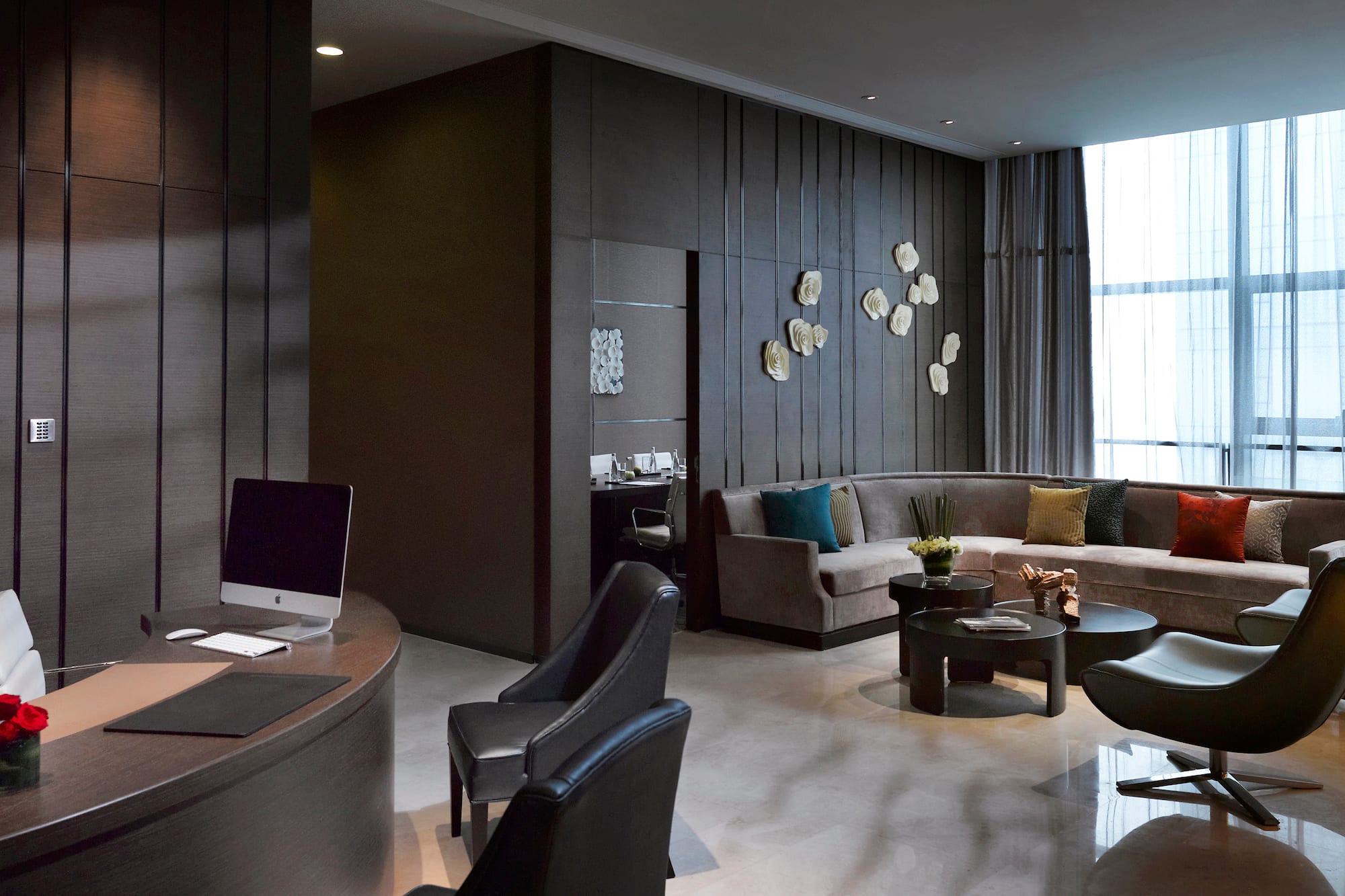 a room with a round table and couches