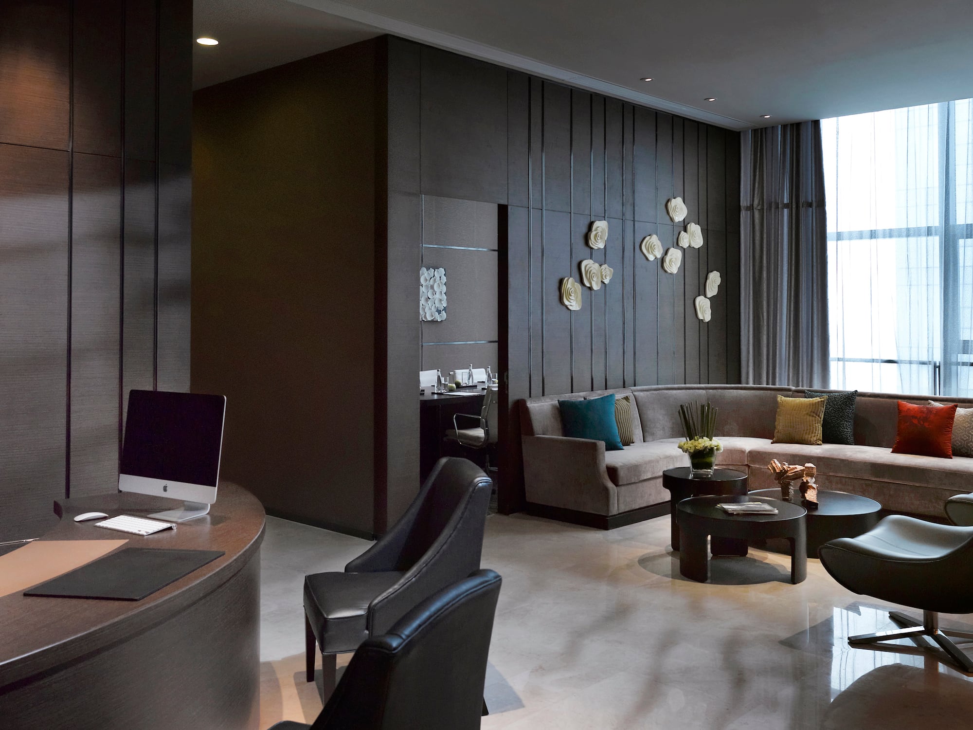 a room with a round table and couches