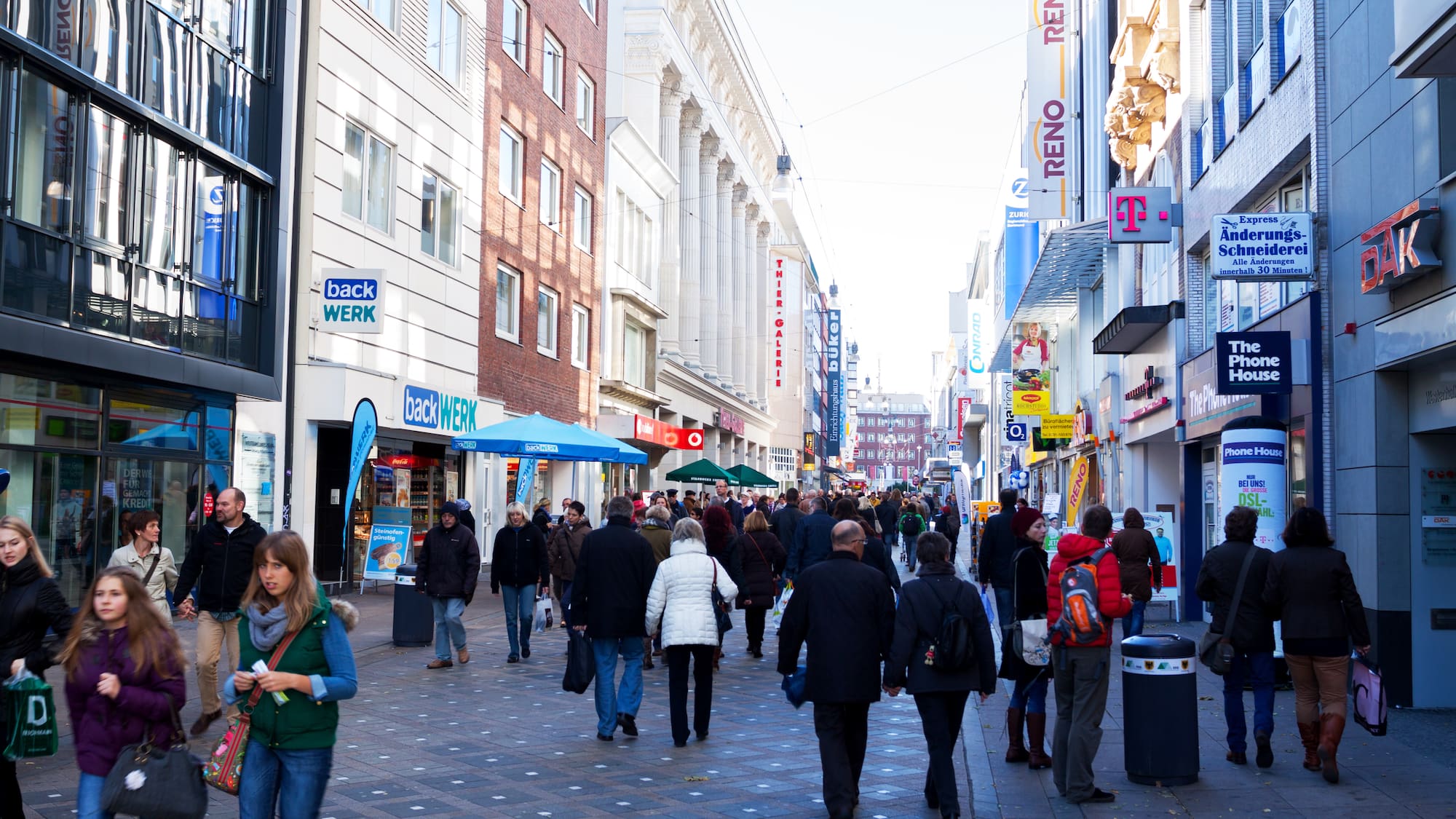 a group of people walking down a street