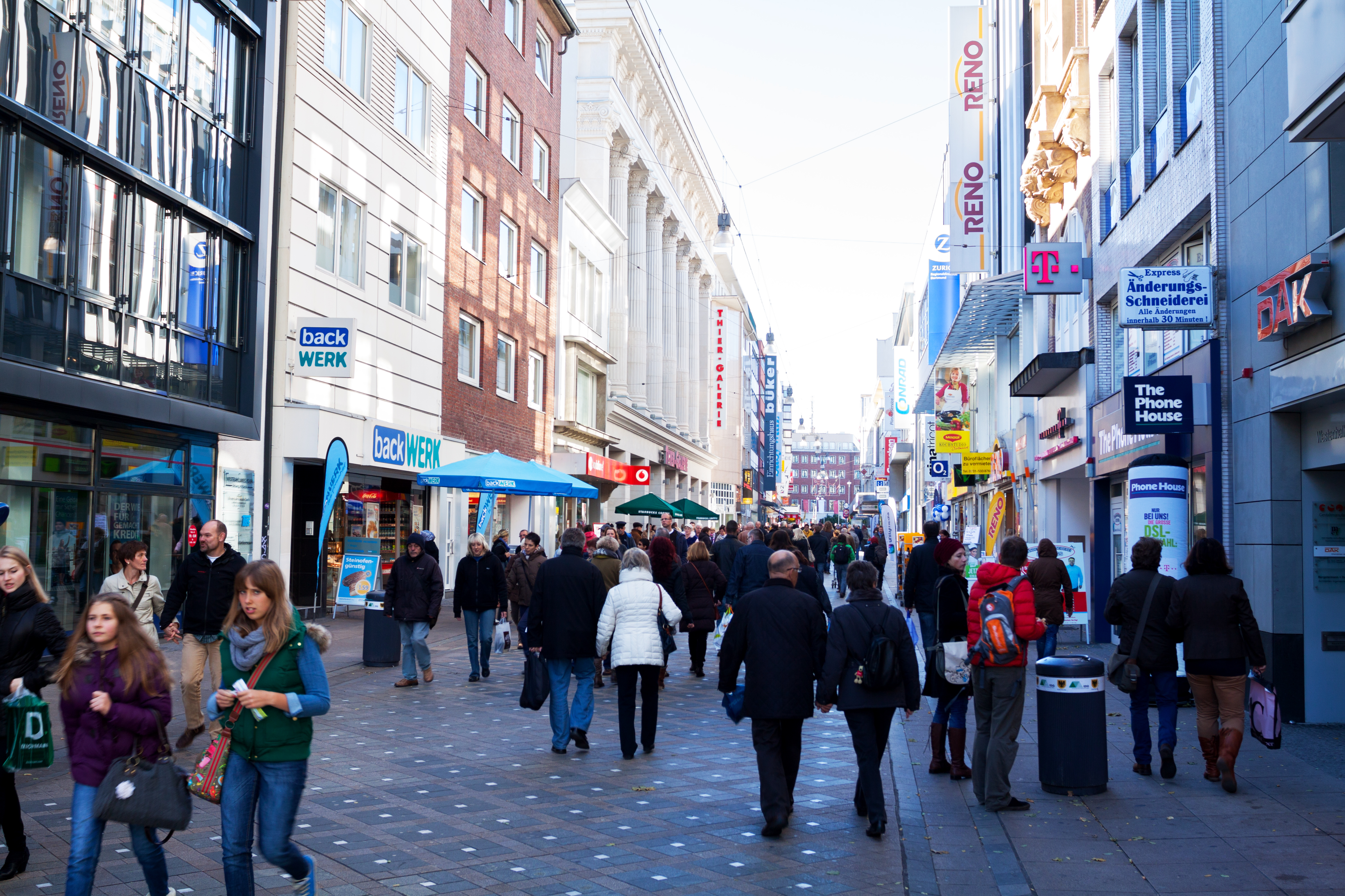 a group of people walking down a street