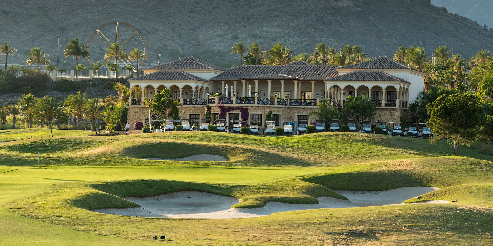 a building with a golf course and a ferris wheel