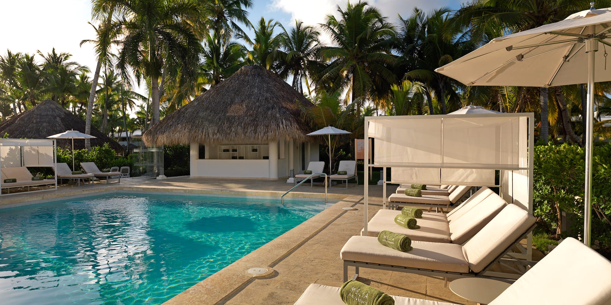 a pool with lounge chairs and umbrellas