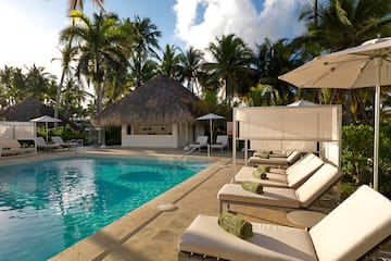 a pool with lounge chairs and umbrellas