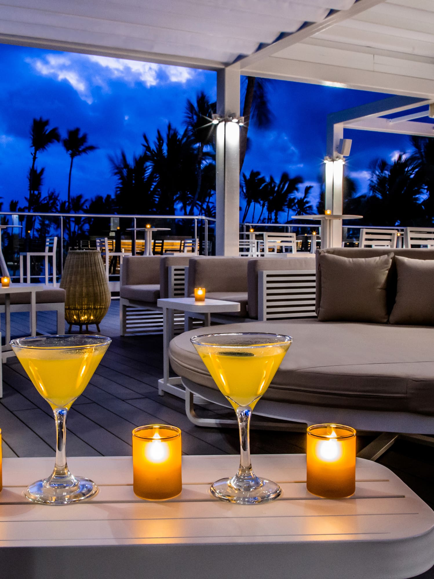a table with drinks and candles on it