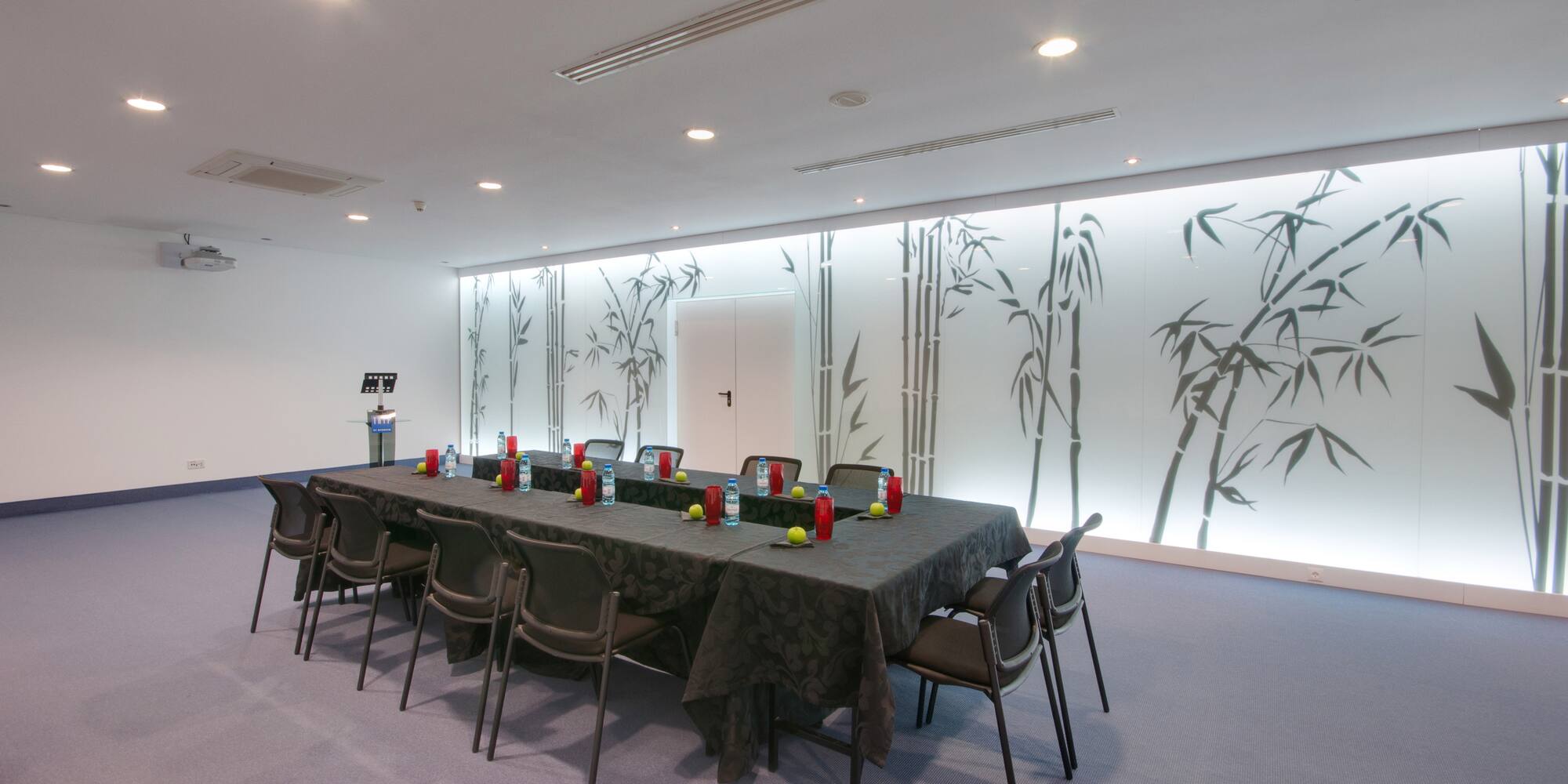 a long table with chairs and a black tablecloth