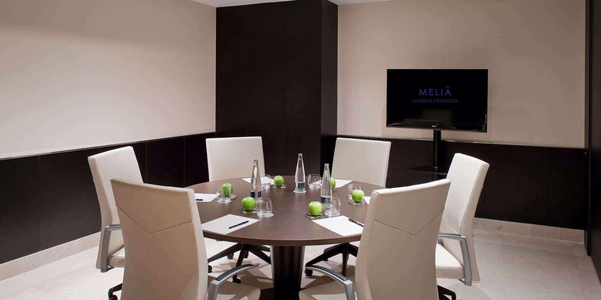 a room with a round table and chairs