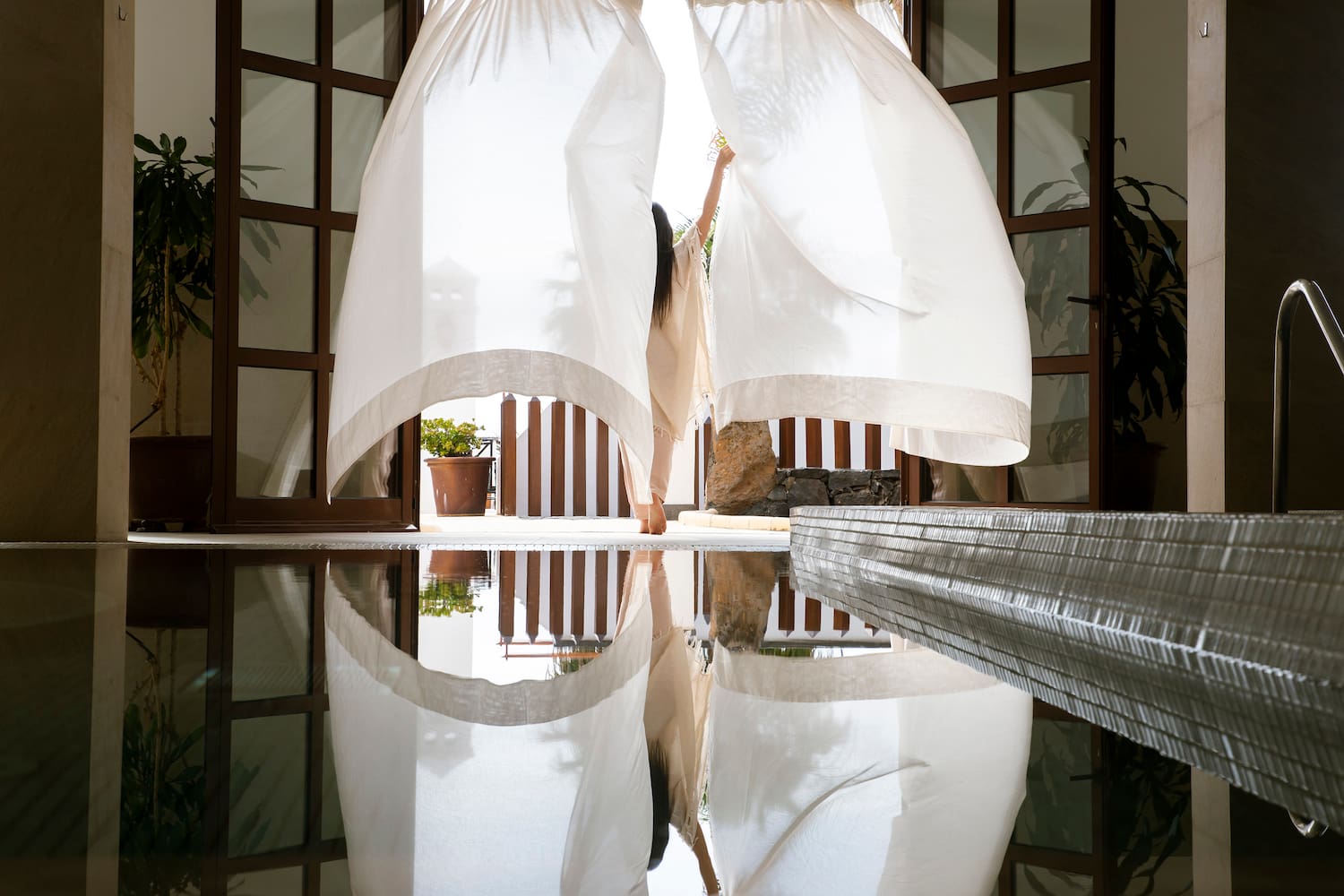 a woman holding a curtain