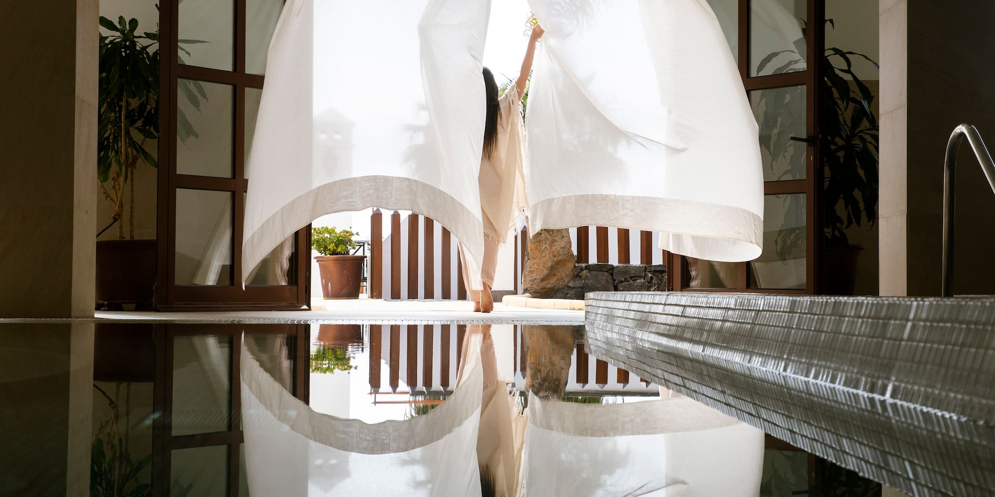 a woman holding a curtain