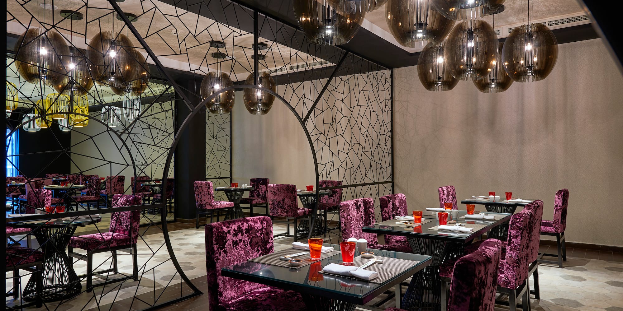 a room with purple chairs and tables