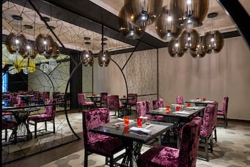 a room with purple chairs and tables