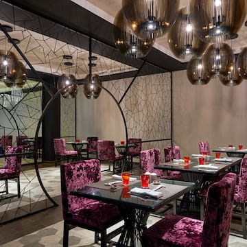 a room with purple chairs and tables